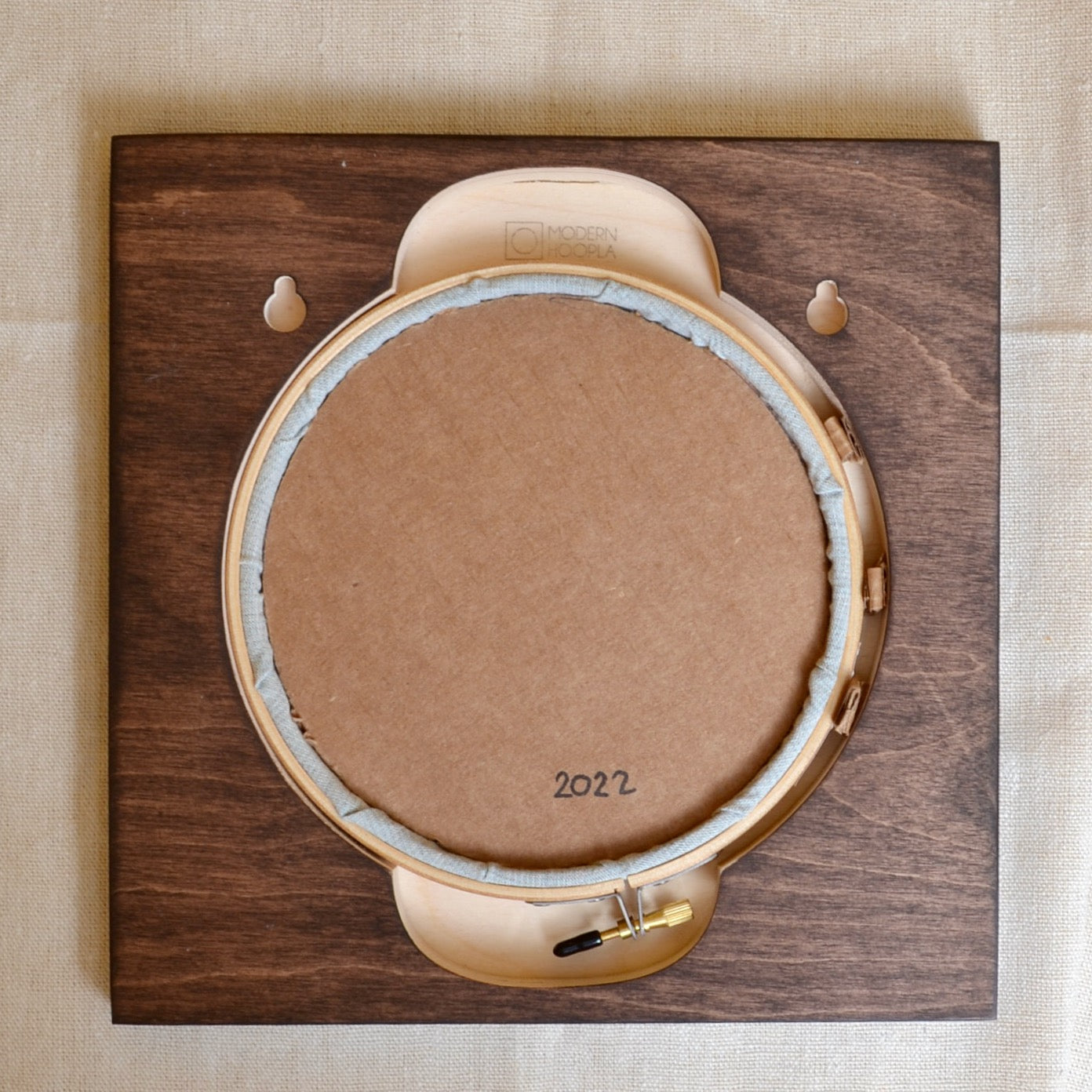 cardboard circle cut for backing embroidery in Modern Hoopla frame