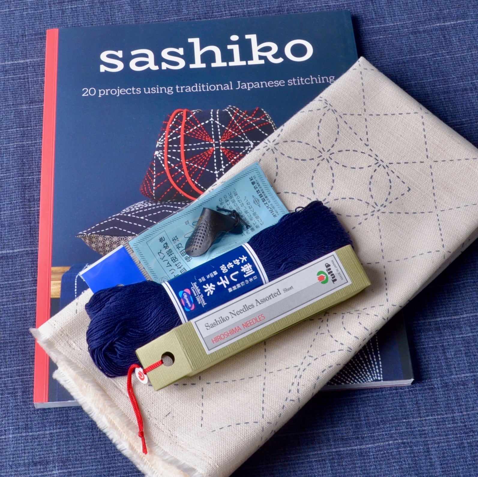 Olymp Sashiko Starter Bundle - 12 Skeins of Olympus Sashiko Thread, 2 Sashiko Needles, and A Leather Sashiko Thimble