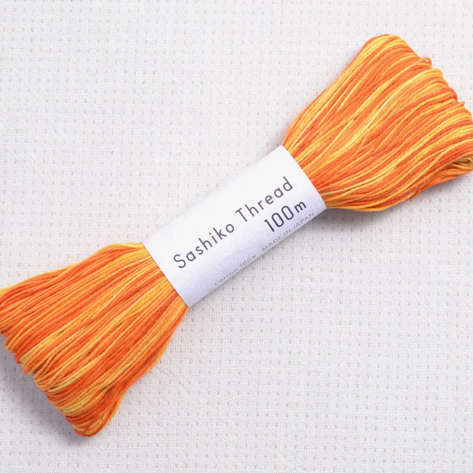 Olympus sashiko thread, 100 meter skein, variegated orange #154