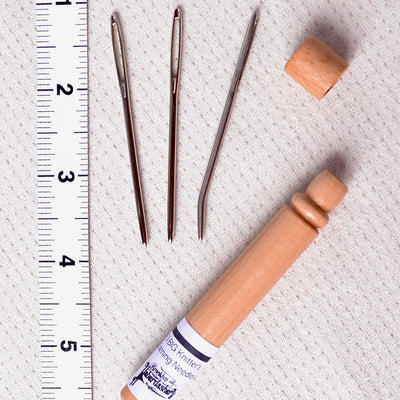 darning needles in wood tube