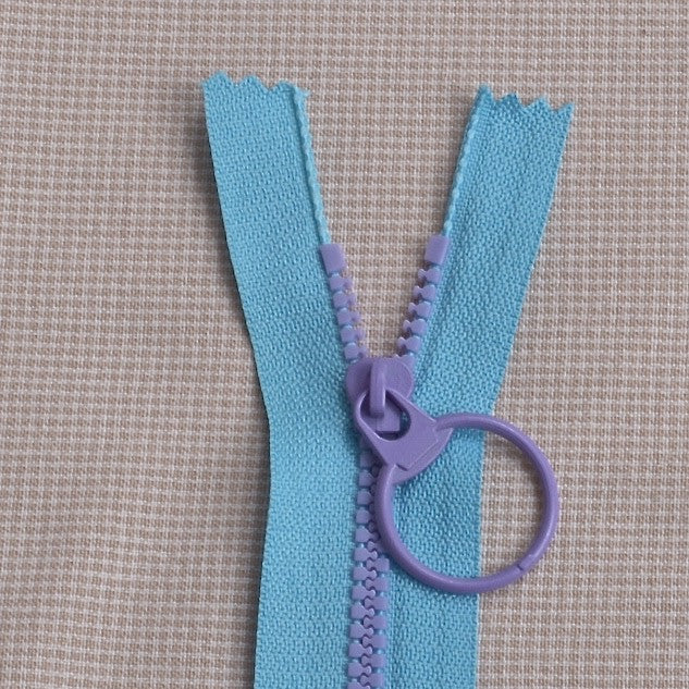 lighter blue with purple teeth zipper